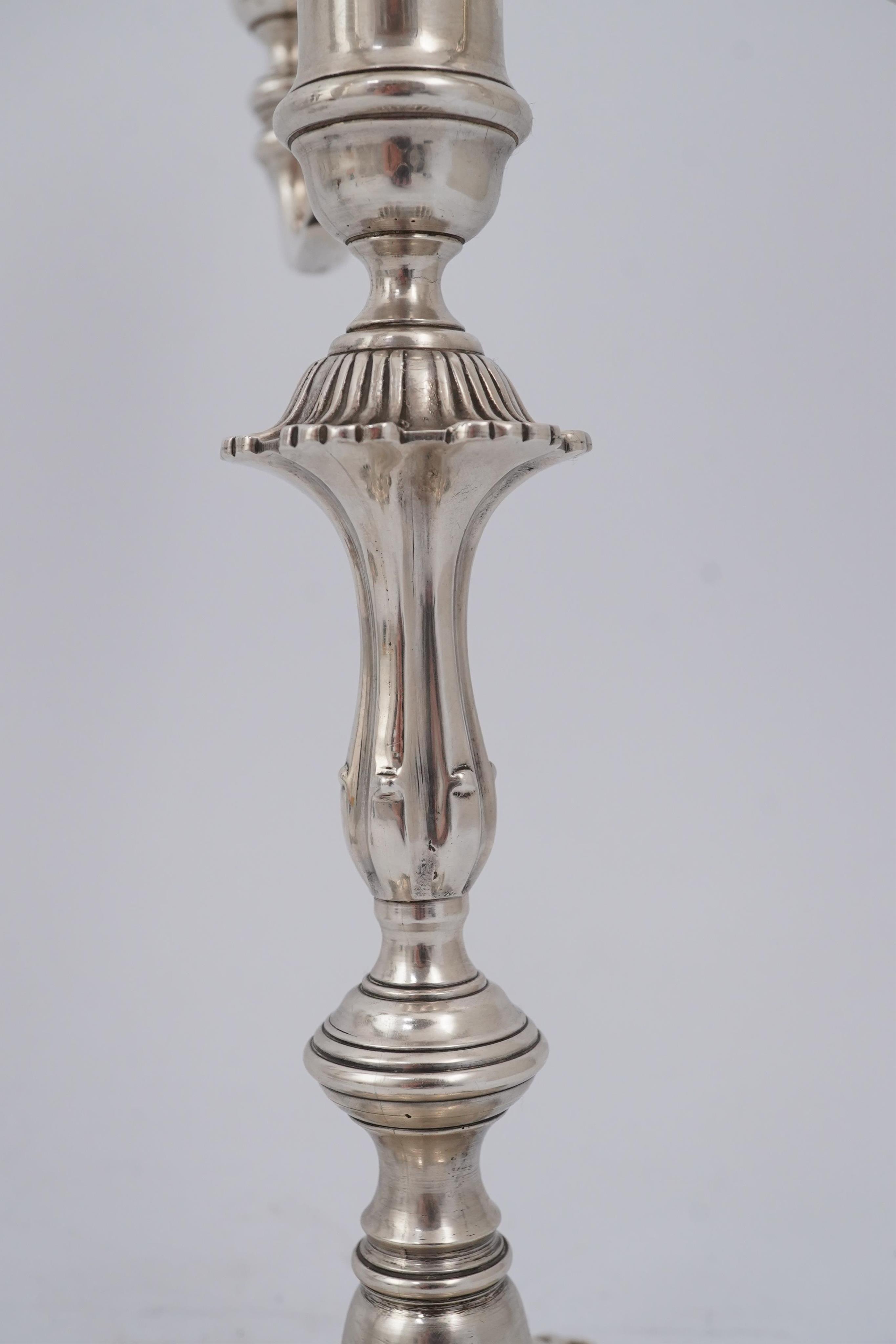 A pair of Elizabeth II cast silver three branch, three light candelabra, by J.B. Chatterley & Sons Ltd